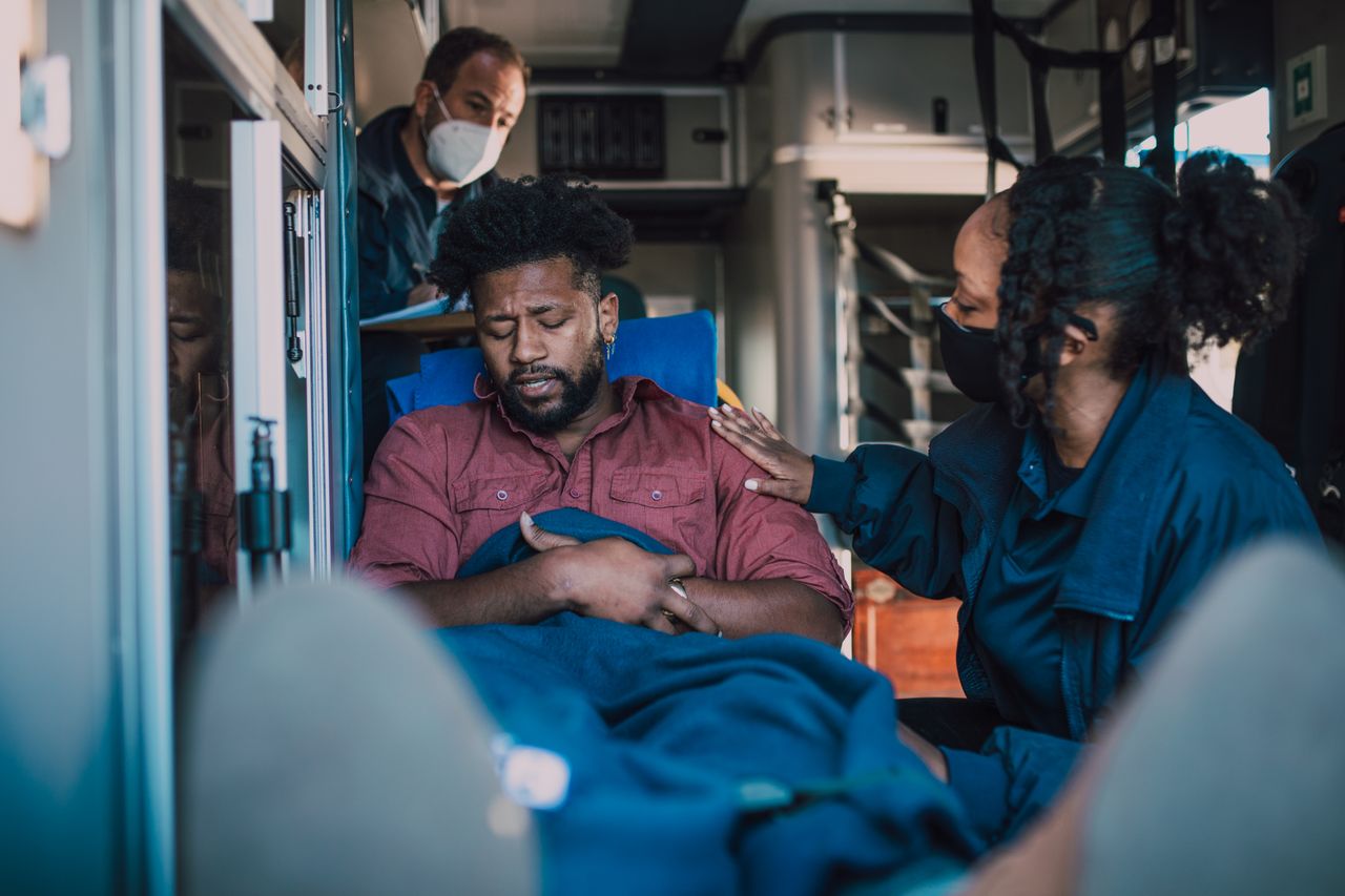 Paramedics provide emergency care to a patient inside an ambulance, ensuring timely medical attention.
